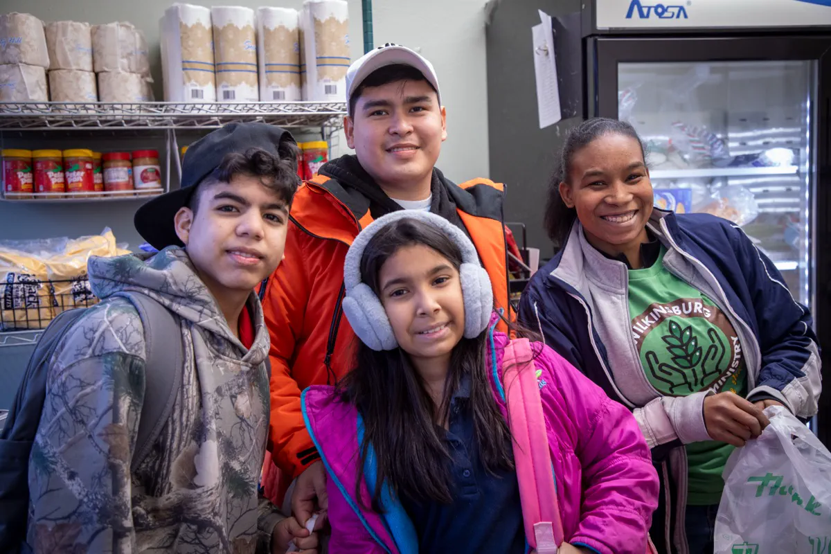 Families picking out kid-friendly food at the pantry
